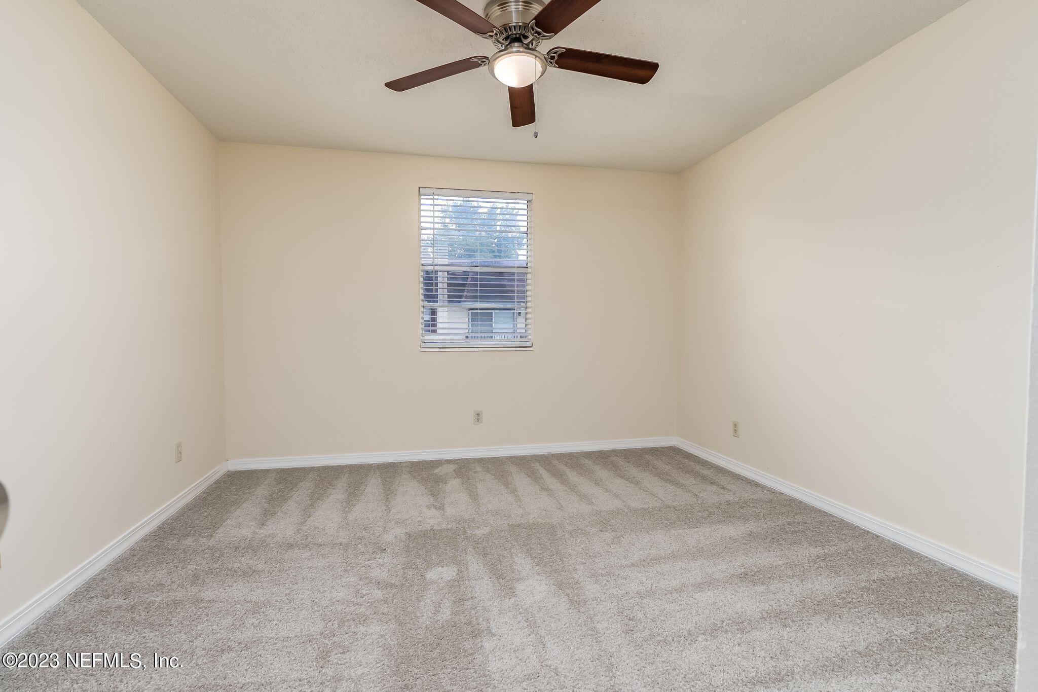 1735 El Camino Road, Unit 5 Jacksonville, FL 32216 - Photo 11 of 26 an empty room with a window and a fan