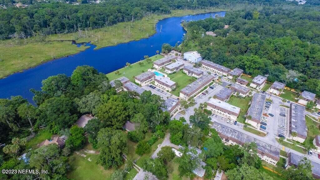 1735 El Camino Road, Unit 5 Jacksonville, FL 32216 - Photo 23 of 26 an aerial view of a house with a garden and lake view