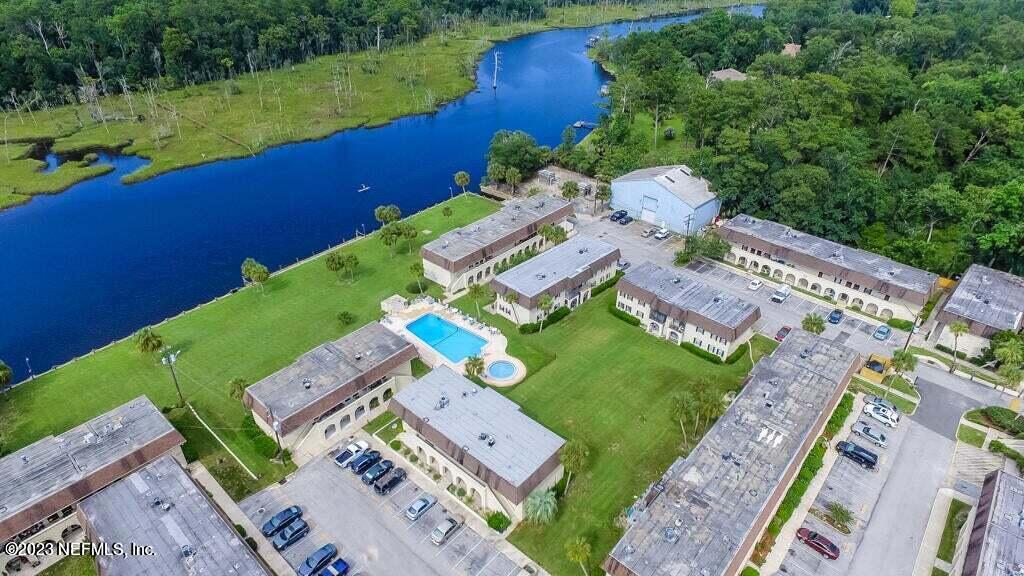 1735 El Camino Road, Unit 5 Jacksonville, FL 32216 - Photo 24 of 26 an aerial view of a house with a garden and lake view