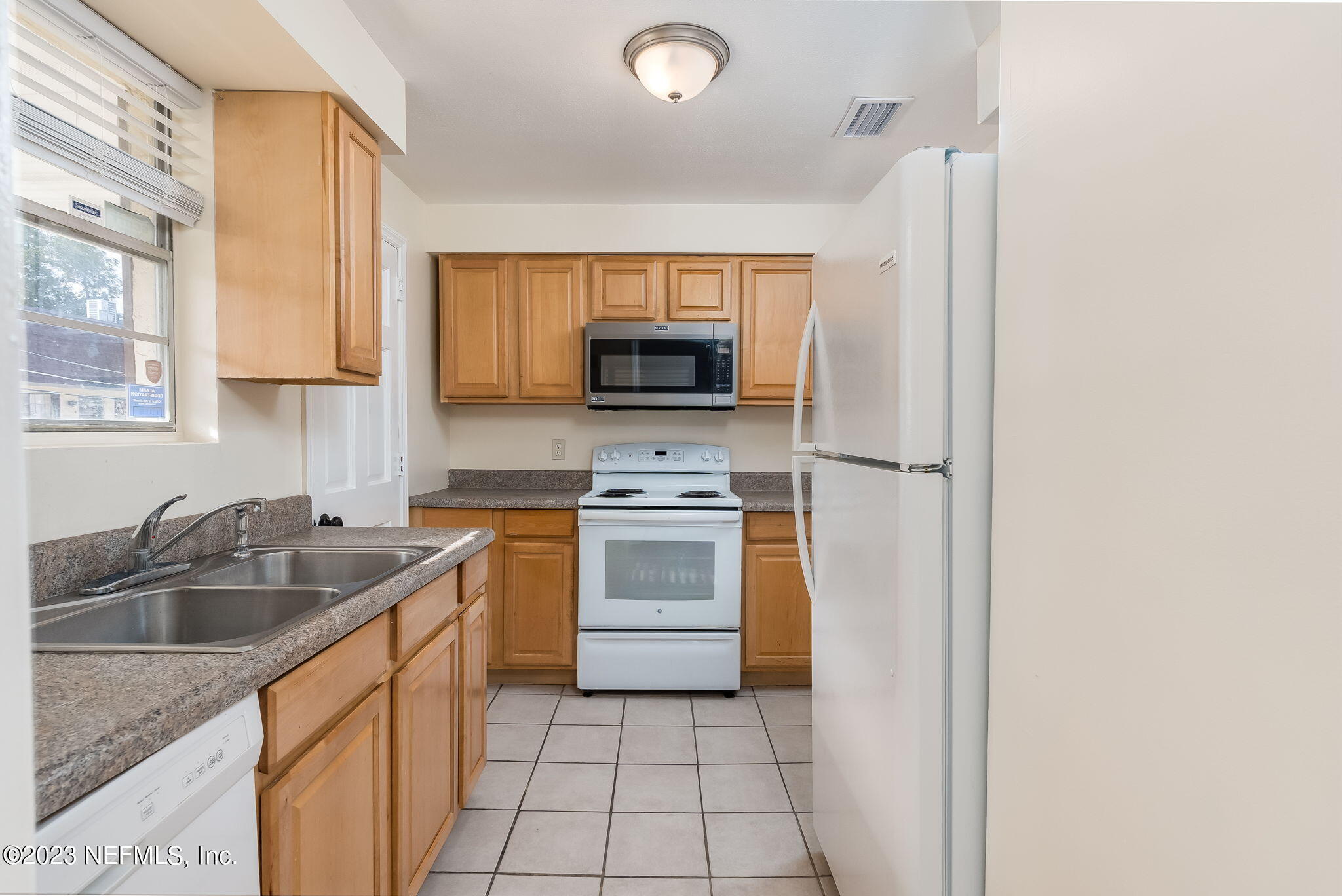 1735 El Camino Road, Unit 5 Jacksonville, FL 32216 - Photo 4 of 26 a kitchen with a sink stove and microwave