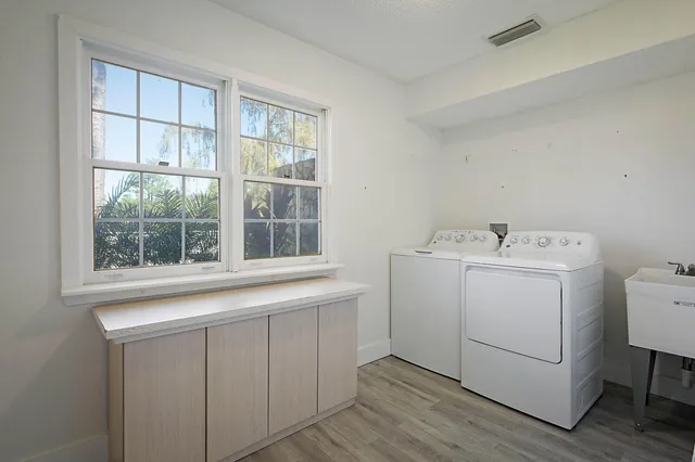a utility room with a sink dryer and washer