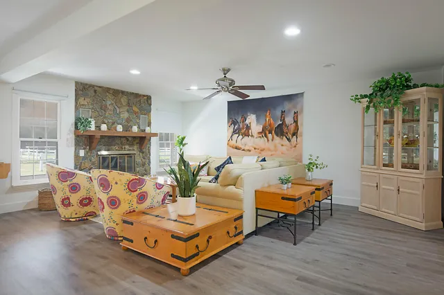 a living room with furniture and wooden floor