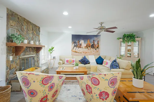 a bedroom with furniture and a large window