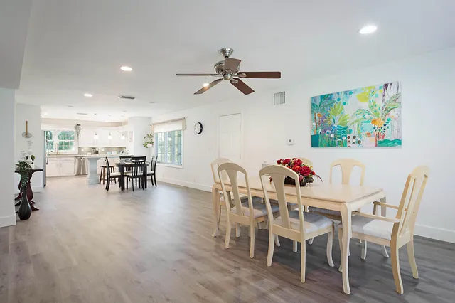 a dining room with furniture and floor to ceiling window