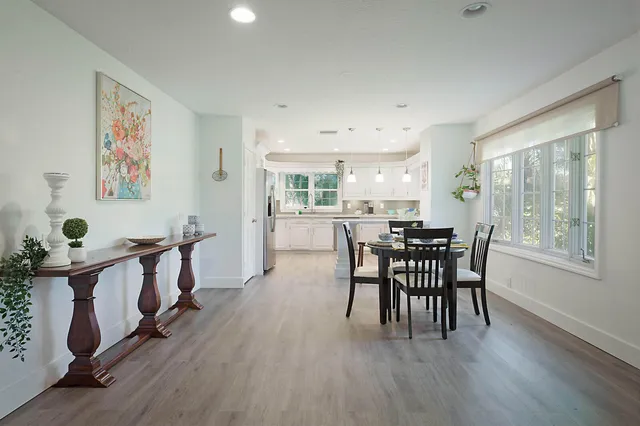 a view of a dining room with furniture and window