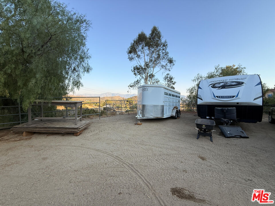 33931 Hanawalt Road Agua Dulce, CA 91390 - Photo 19 of 22 a view of a terrace with a table and chairs