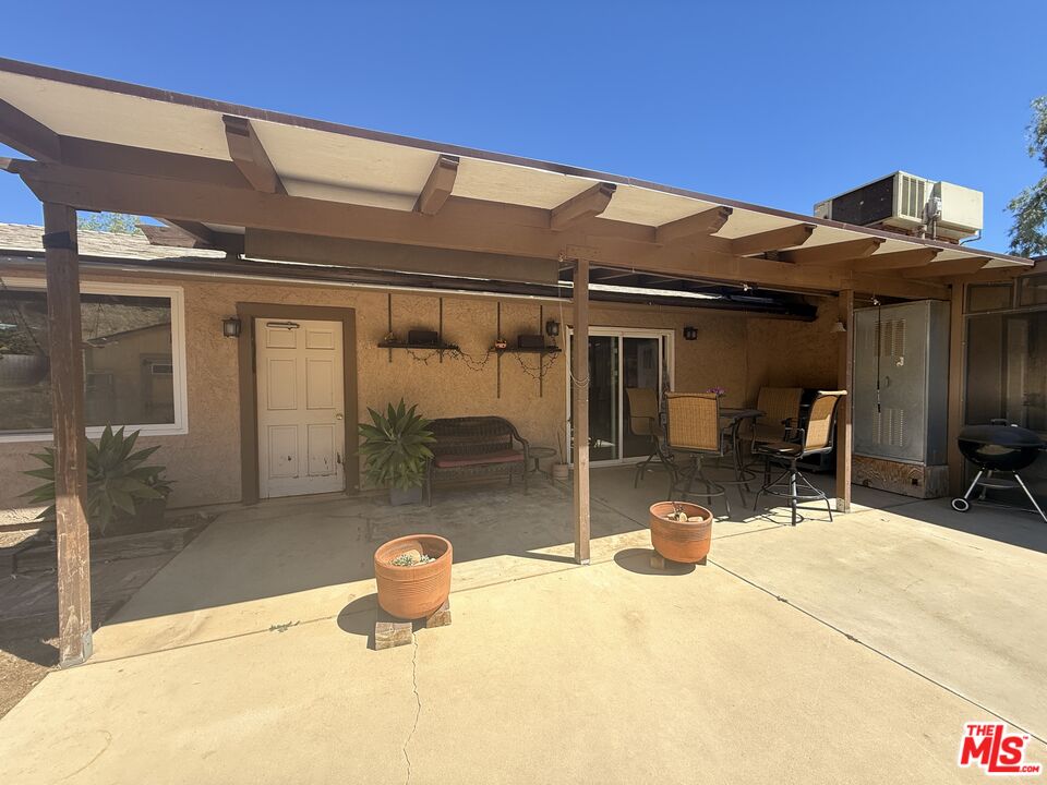 33931 Hanawalt Road Agua Dulce, CA 91390 - Photo 4 of 22 a view of a patio with table and chairs near a barbeque