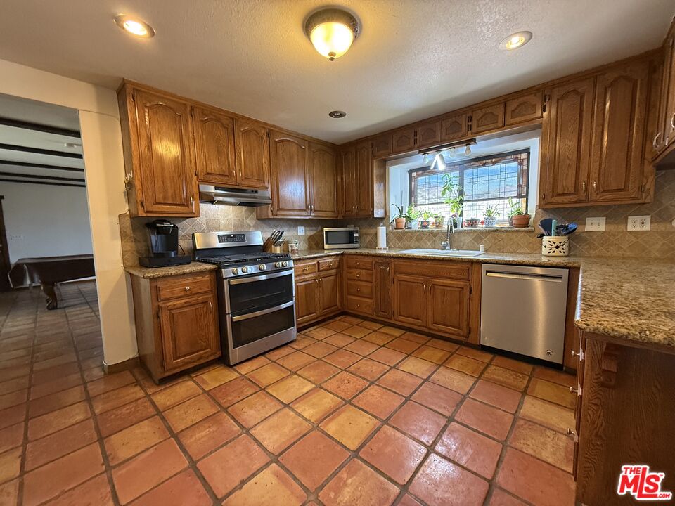 33931 Hanawalt Road Agua Dulce, CA 91390 - Photo 7 of 22 a kitchen with stainless steel appliances granite countertop a sink and cabinets