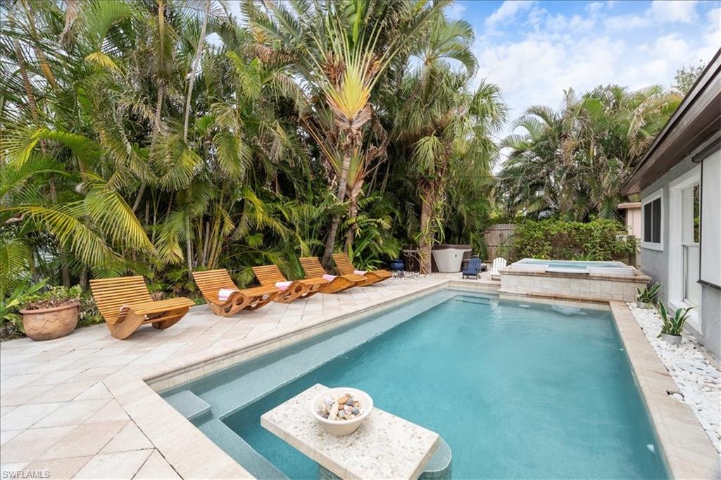 a view of a swimming pool with a lounge chair