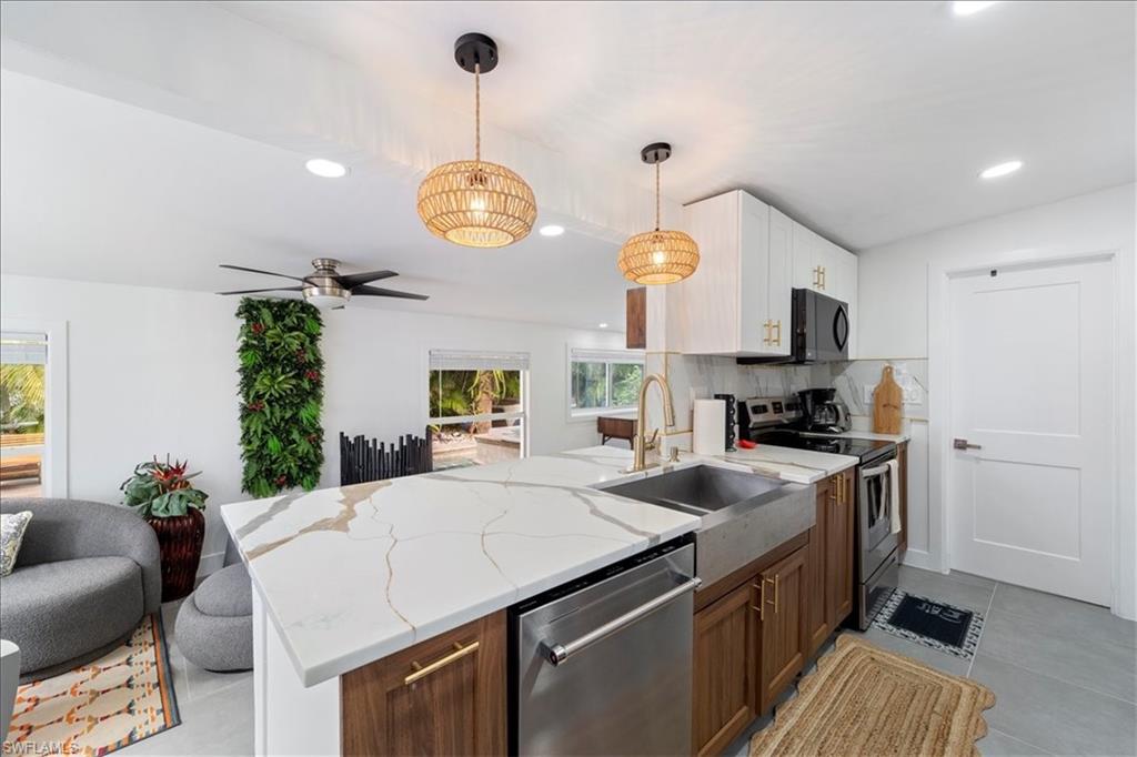 2123 Holiday Lane Naples, FL 34104 - Photo 41 of 43 Kitchen featuring open floor plan, appliances with stainless steel finishes, a peninsula, backsplash, and recessed lighting