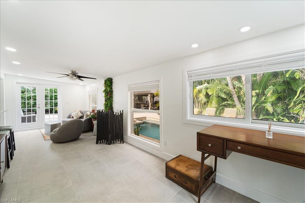 2123 Holiday Lane Naples, FL 34104 - Photo 16 of 43 a living room with furniture and a window