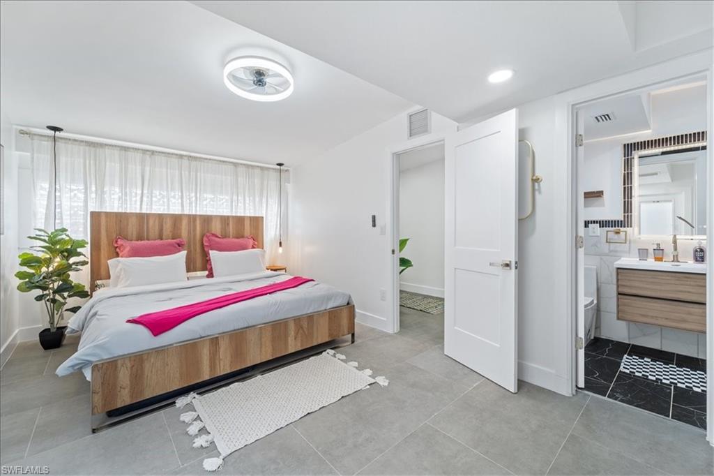 2123 Holiday Lane Naples, FL 34104 - Photo 18 of 43 a bedroom with a bed and a potted plant