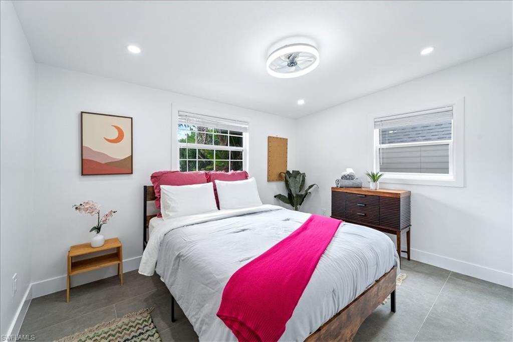 2123 Holiday Lane Naples, FL 34104 - Photo 21 of 43 a bed room with a bed and a couch