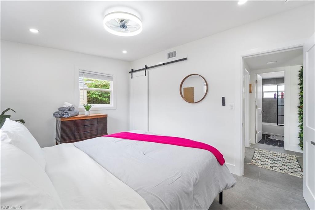 2123 Holiday Lane Naples, FL 34104 - Photo 22 of 43 a bedroom with a bed and a window