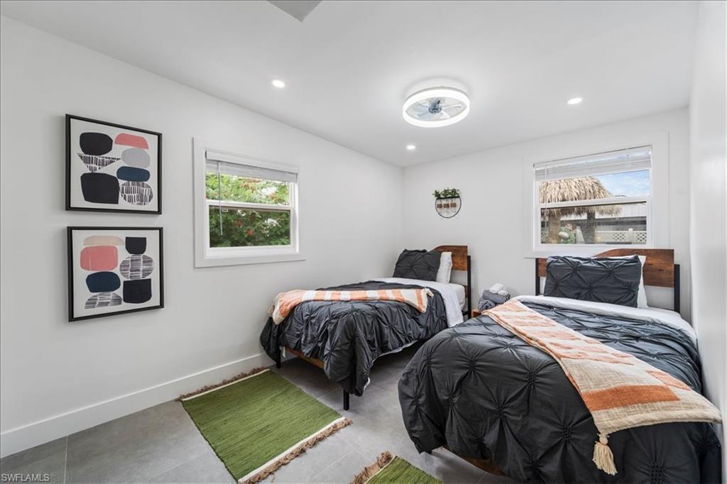 2123 Holiday Lane Naples, FL 34104 - Photo 23 of 43 a bedroom with two beds and painting on the wall