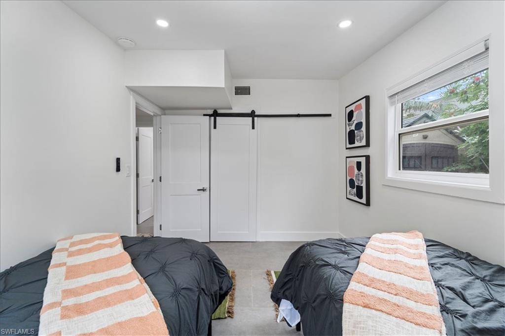 2123 Holiday Lane Naples, FL 34104 - Photo 24 of 43 a bedroom with bed and a window