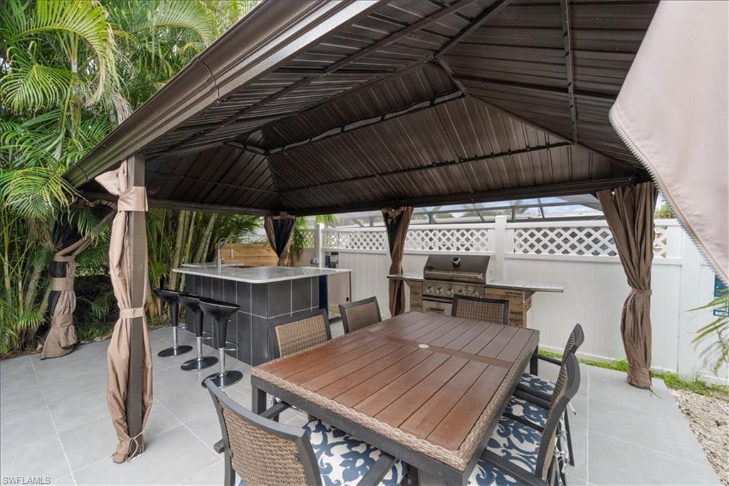 2123 Holiday Lane Naples, FL 34104 - Photo 31 of 43 a view of backyard with sitting area