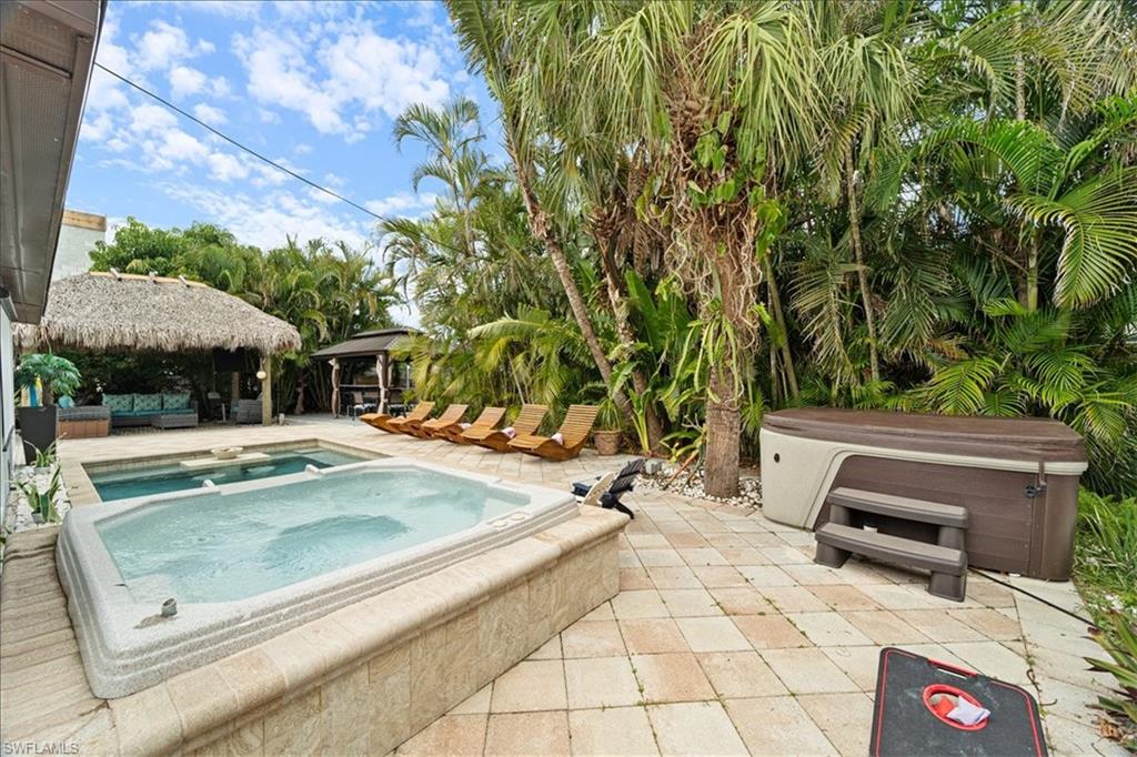 2123 Holiday Lane Naples, FL 34104 - Photo 36 of 43 a view of backyard with swimming pool table and chairs
