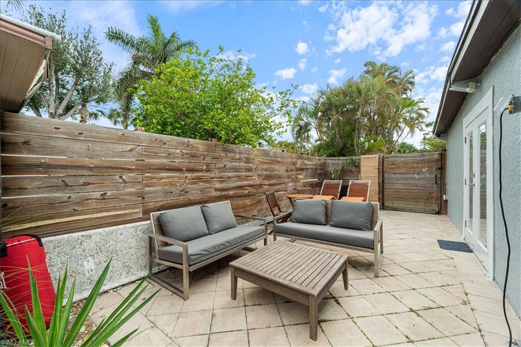 2123 Holiday Lane Naples, FL 34104 - Photo 37 of 43 Fenced backyard with a patio, an outdoor hangout area, and french doors