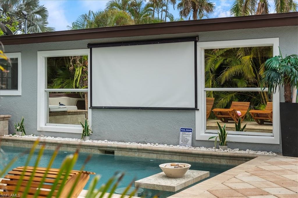 2123 Holiday Lane Naples, FL 34104 - Photo 39 of 43 a view of a swimming pool with a lounge chairs