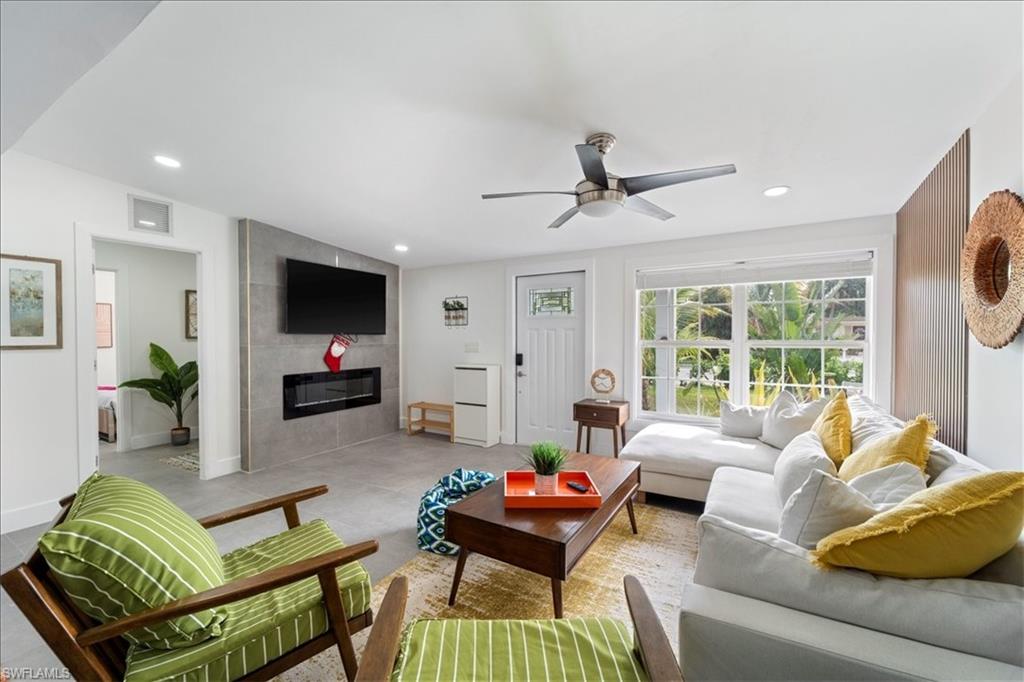 2123 Holiday Lane Naples, FL 34104 - Photo 5 of 43 a living room with furniture and a flat screen tv