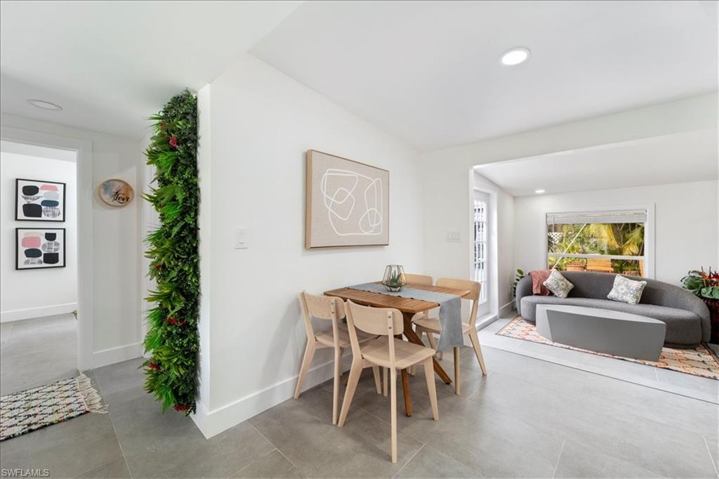 2123 Holiday Lane Naples, FL 34104 - Photo 8 of 43 a dining room with furniture and wooden floor