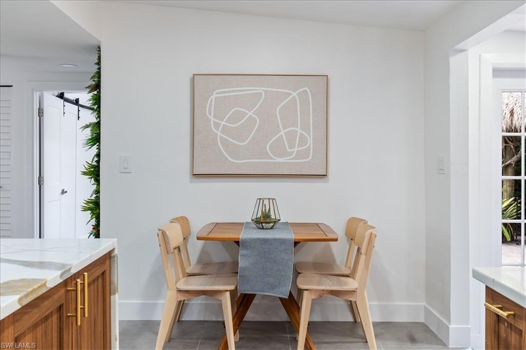 2123 Holiday Lane Naples, FL 34104 - Photo 9 of 43 a view of a dining room that has a table and chair