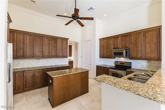 a kitchen with a sink appliances and cabinets