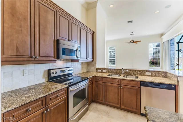 a kitchen with a sink stove and microwave