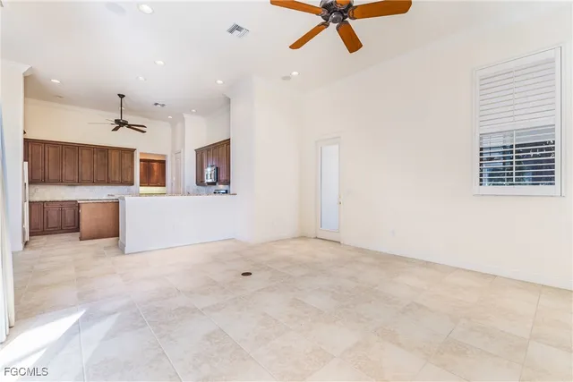 a view of a livingroom with a ceiling fan and window
