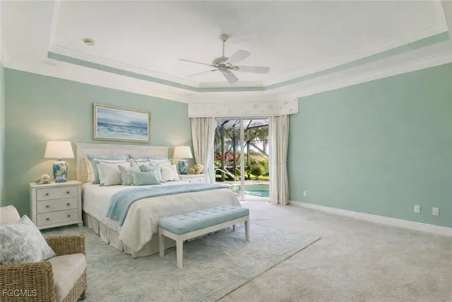 a spacious bedroom with a bed and a chandelier