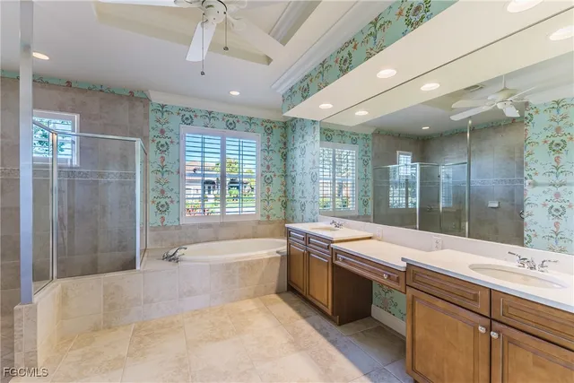 a large spacious bathroom with a granite countertop tub sink shower and mirror