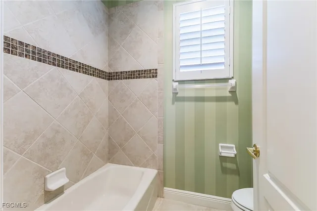 a bathroom with a shower and a toilet