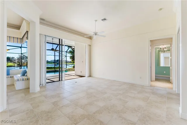 a view of an empty room with a window and bathroom