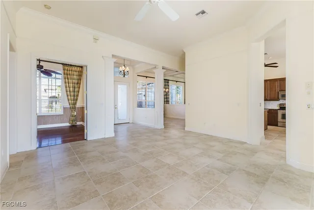 an empty room with entrance and windows