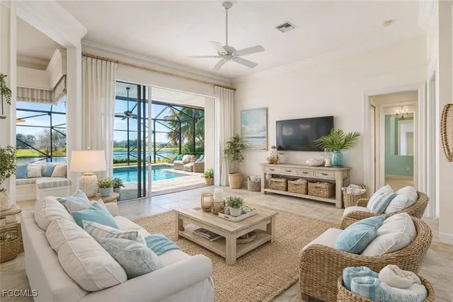 a living room with furniture flat screen tv and a large window