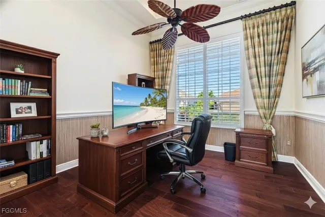 a view of a workspace with furniture and a window