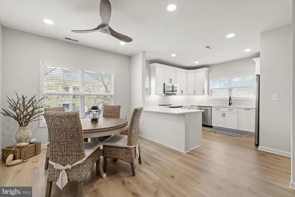 a kitchen with a table chairs sink and cabinets