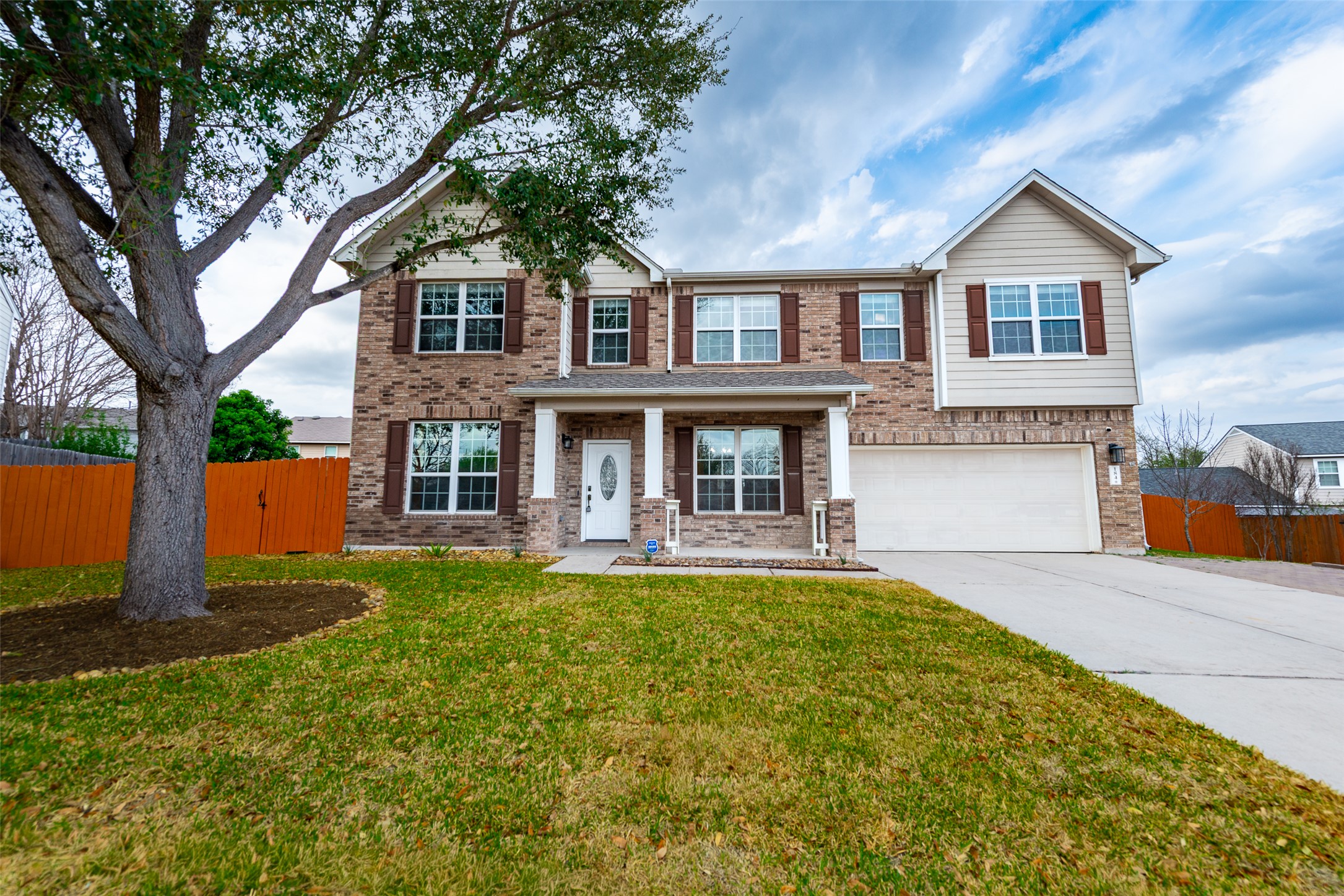 184 Tulip Cove Kyle, TX 78640 - Photo 1 of 40 a front view of a house with swimming pool and porch with furniture