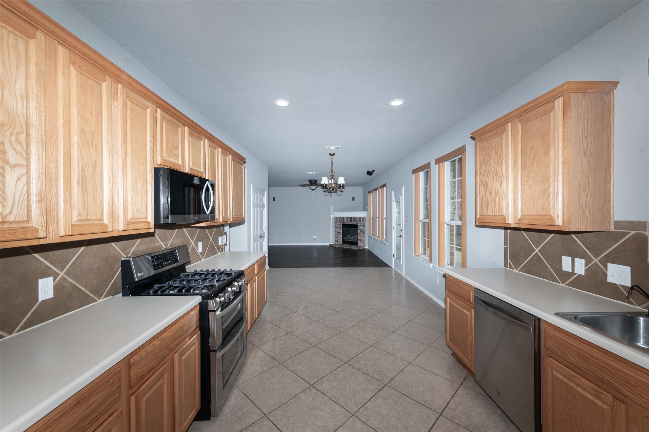 184 Tulip Cove Kyle, TX 78640 - Photo 12 of 40 a kitchen with stainless steel appliances a stove sink and microwave