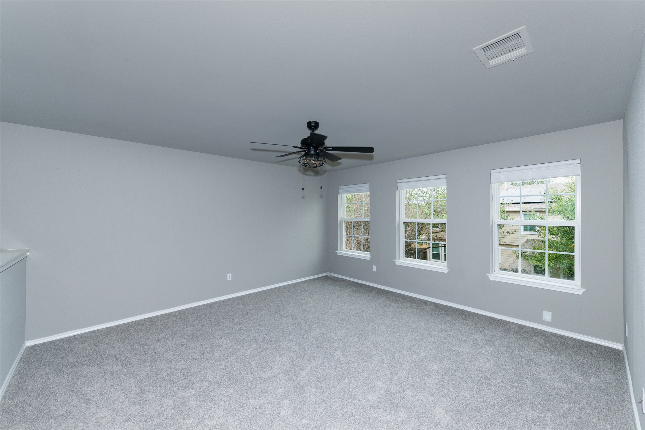 184 Tulip Cove Kyle, TX 78640 - Photo 16 of 40 an empty room with windows and fan