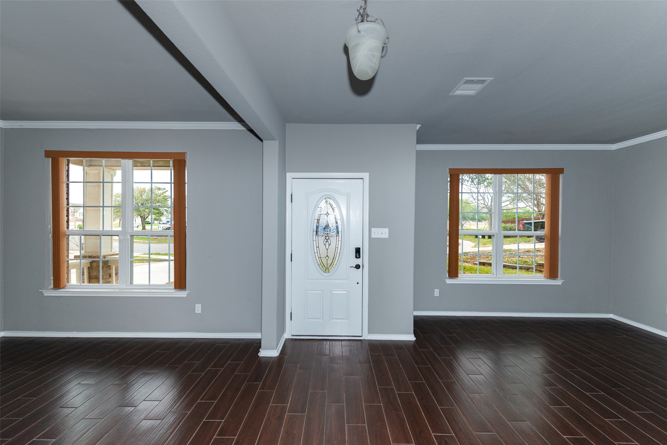 184 Tulip Cove Kyle, TX 78640 - Photo 2 of 40 a view of an empty room with wooden floor and a window