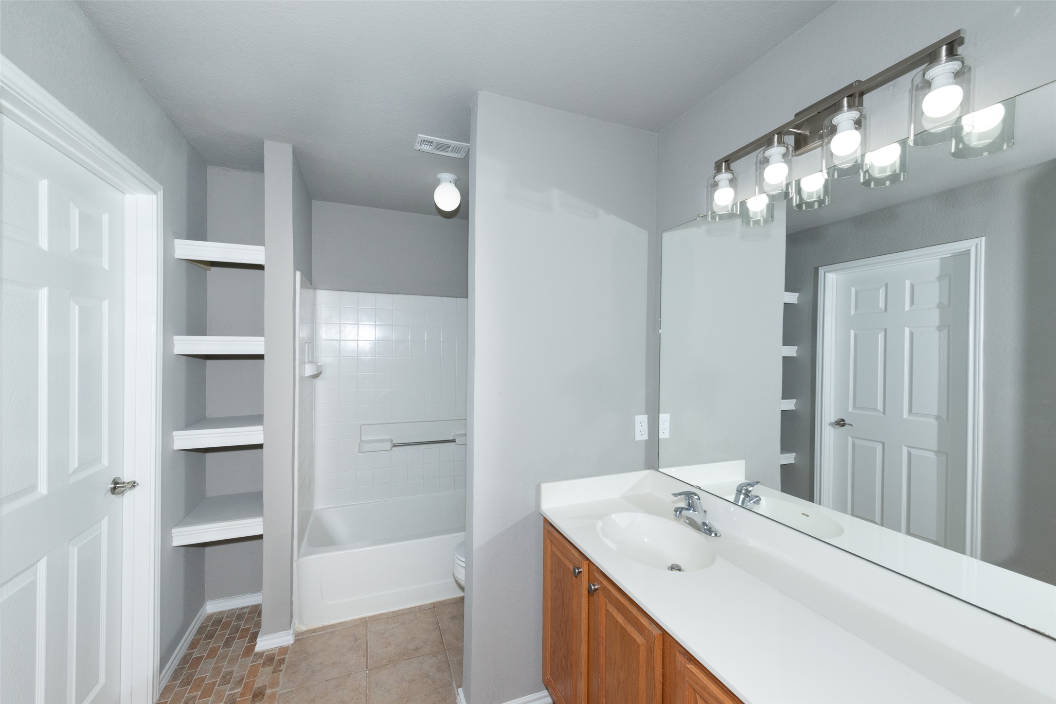 184 Tulip Cove Kyle, TX 78640 - Photo 24 of 40 a bathroom with a sink double vanity and a mirror