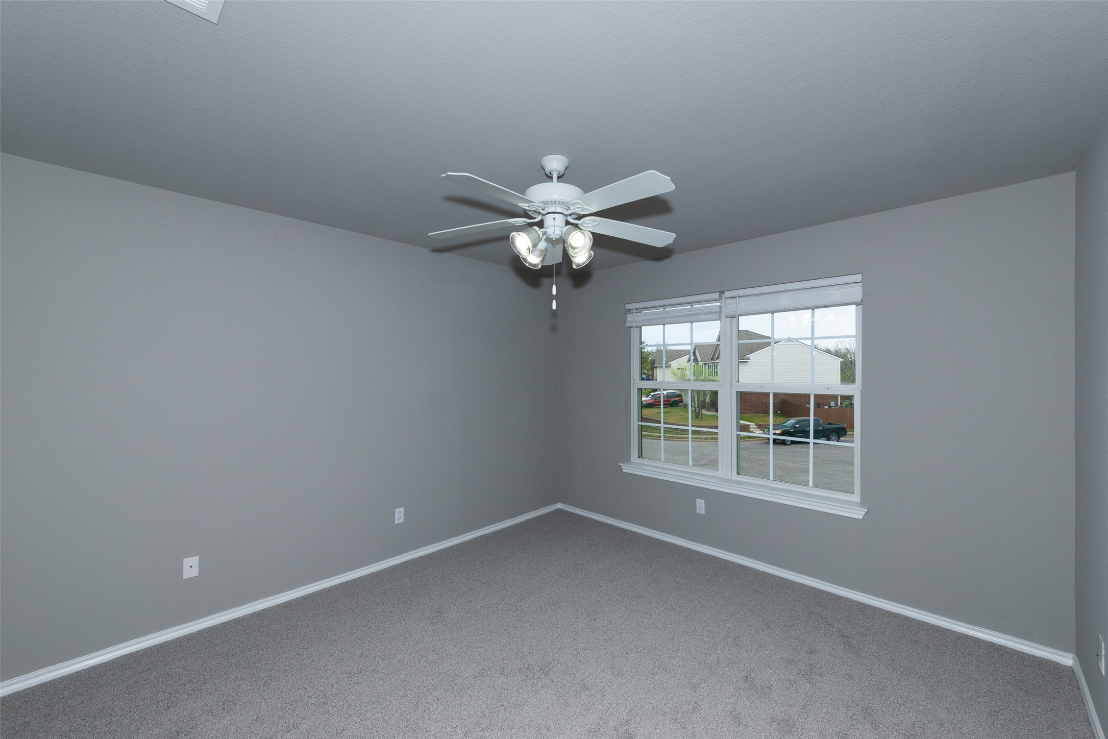 184 Tulip Cove Kyle, TX 78640 - Photo 26 of 40 an empty room with a window and a ceiling fan