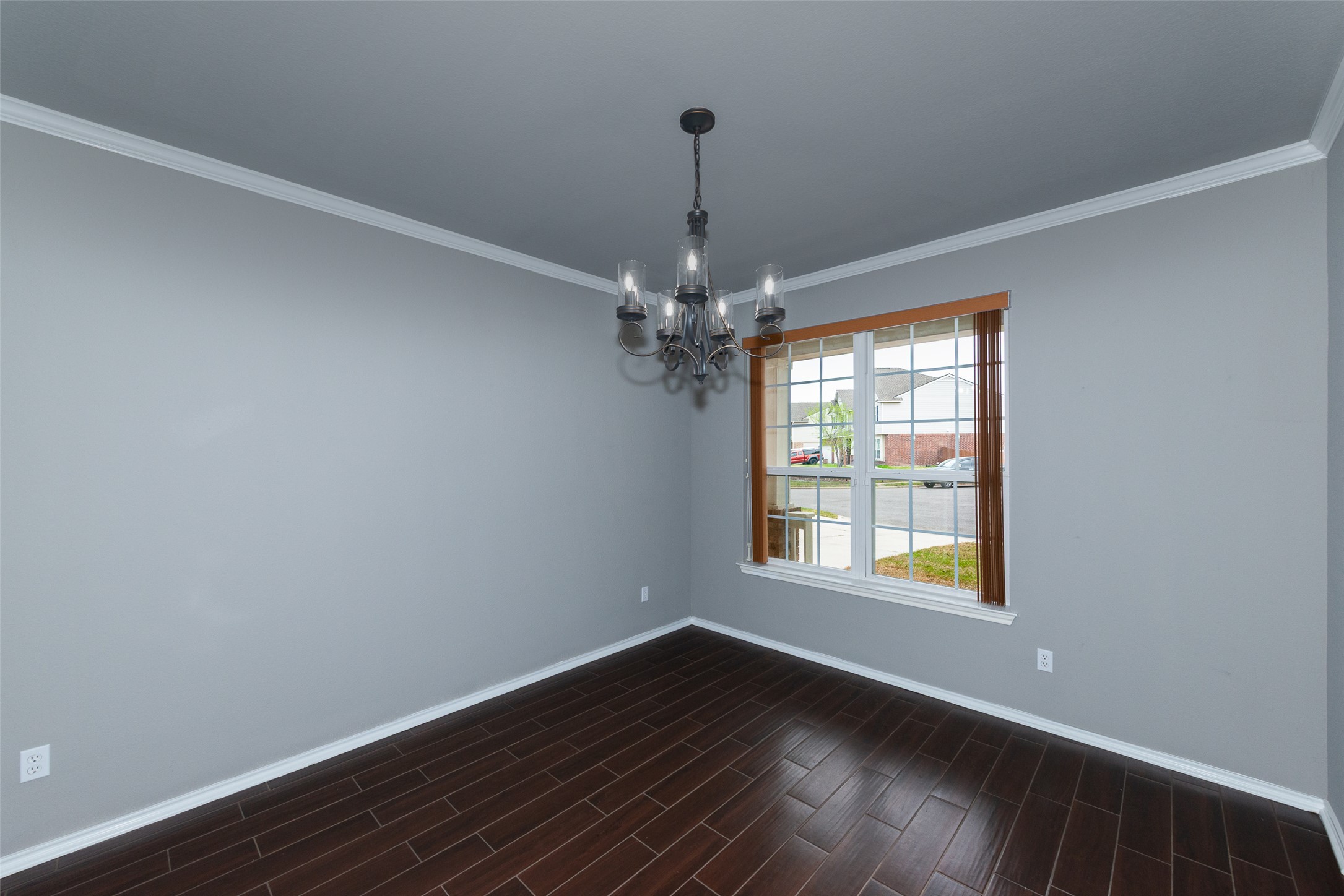 184 Tulip Cove Kyle, TX 78640 - Photo 3 of 40 a view of an empty room with wooden floor and a window