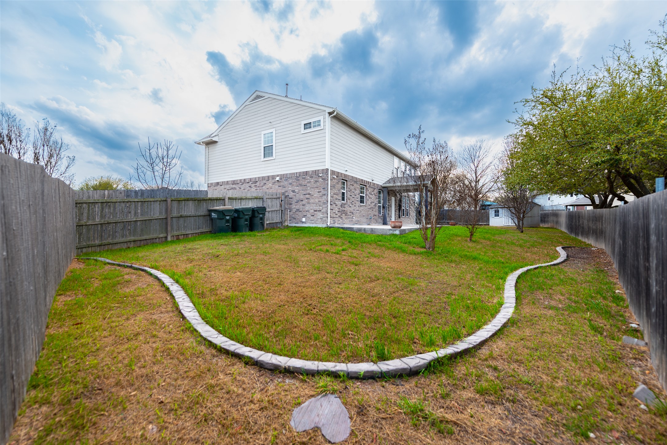 184 Tulip Cove Kyle, TX 78640 - Photo 33 of 40 a view of a house with a backyard
