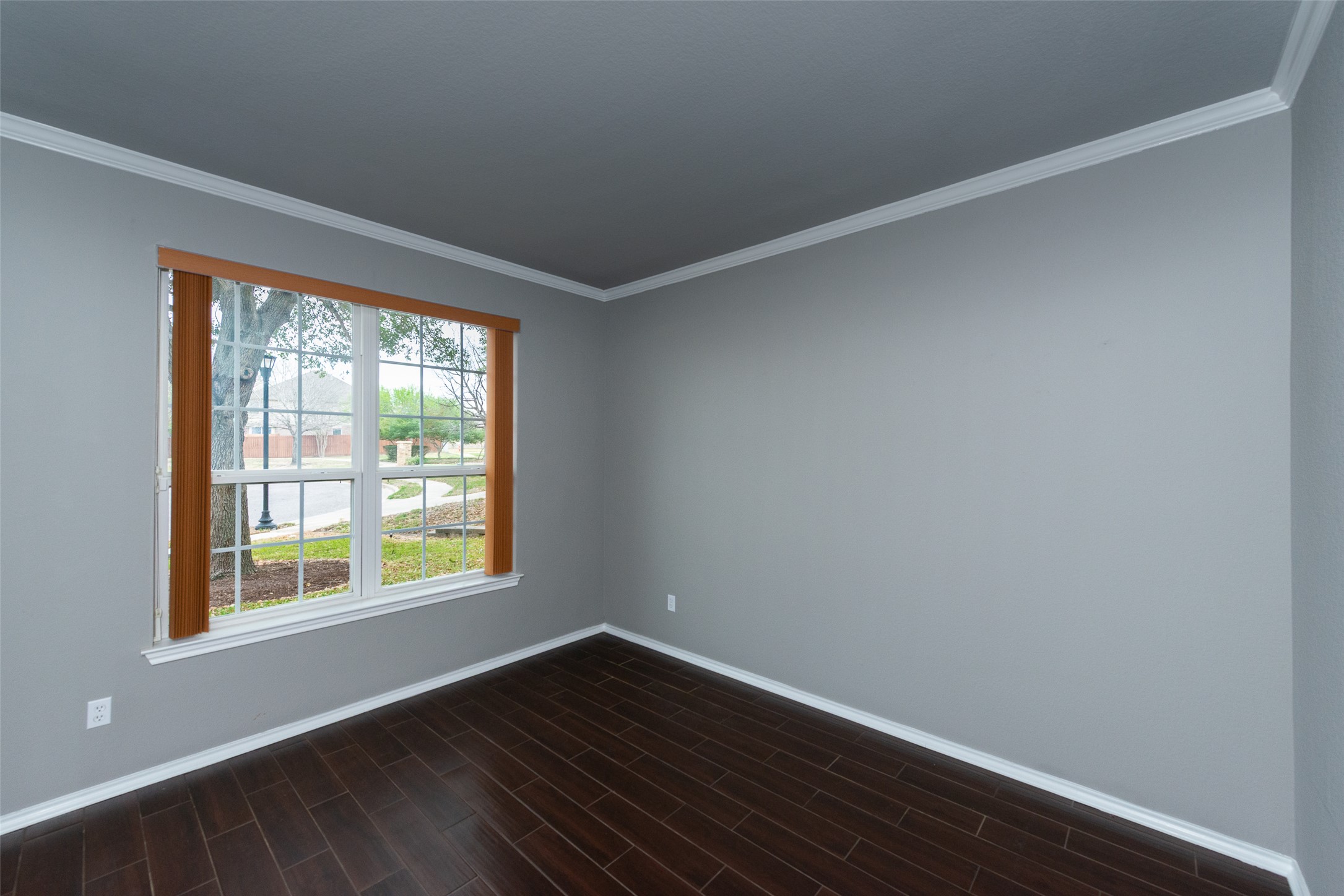 184 Tulip Cove Kyle, TX 78640 - Photo 4 of 40 a view of an empty room with wooden floor and a window