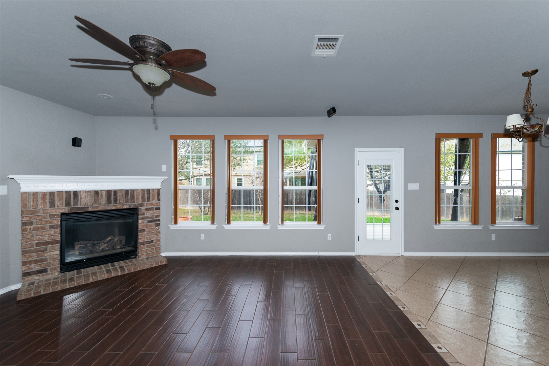 184 Tulip Cove Kyle, TX 78640 - Photo 6 of 40 a view of an empty room with wooden floor fireplace and a window