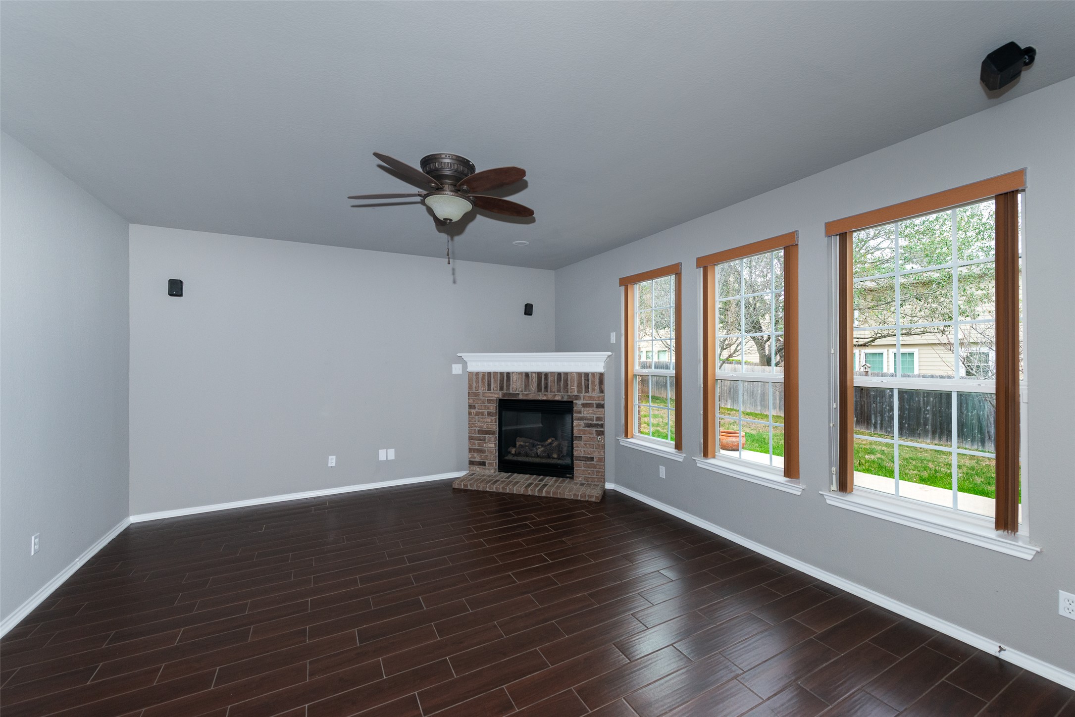 184 Tulip Cove Kyle, TX 78640 - Photo 7 of 40 a view of an empty room with wooden floor and a window