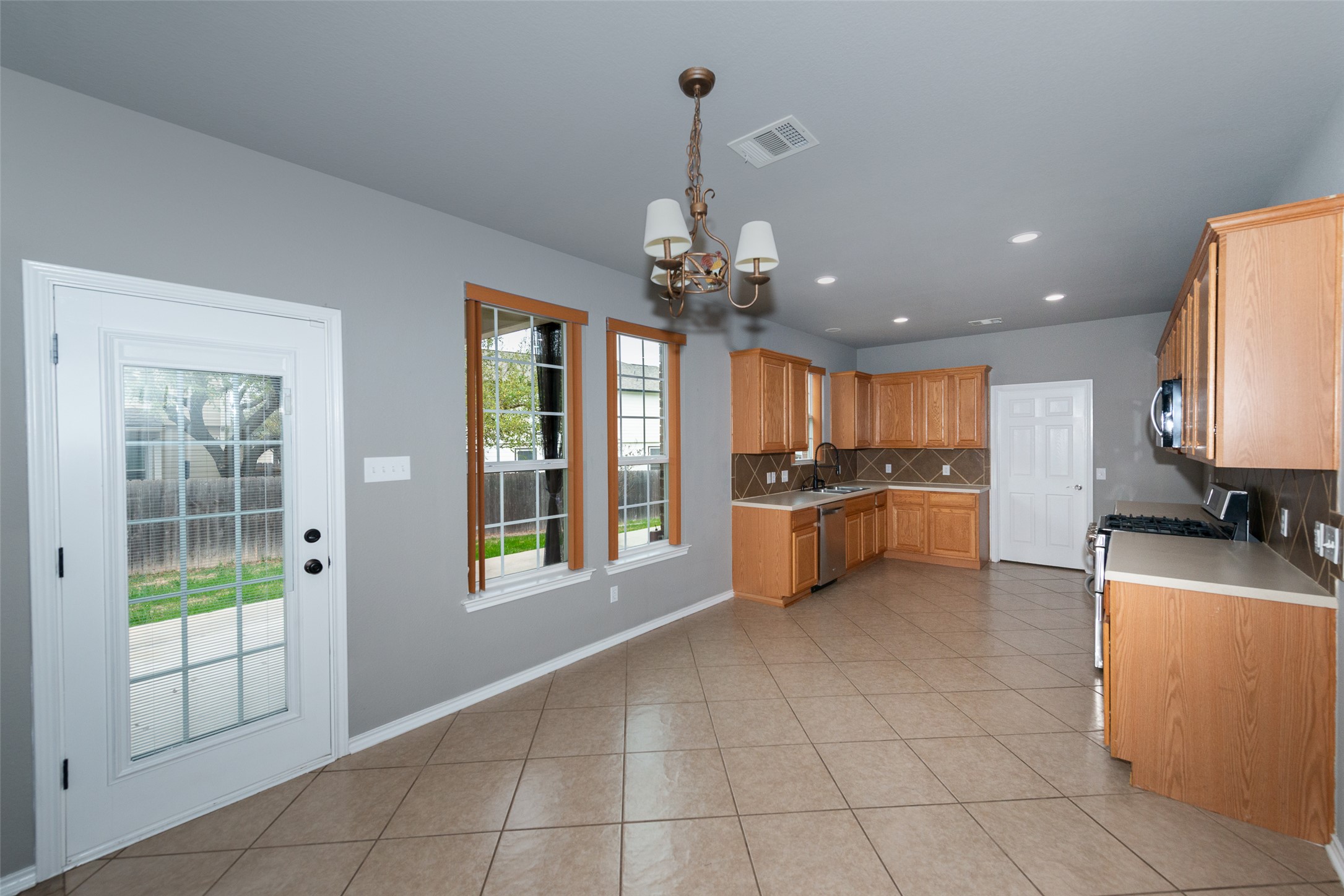 184 Tulip Cove Kyle, TX 78640 - Photo 8 of 40 a kitchen with stainless steel appliances granite countertop a sink and cabinets